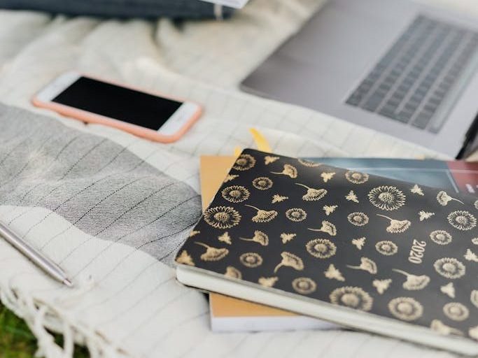 Crop student preparing homework in park